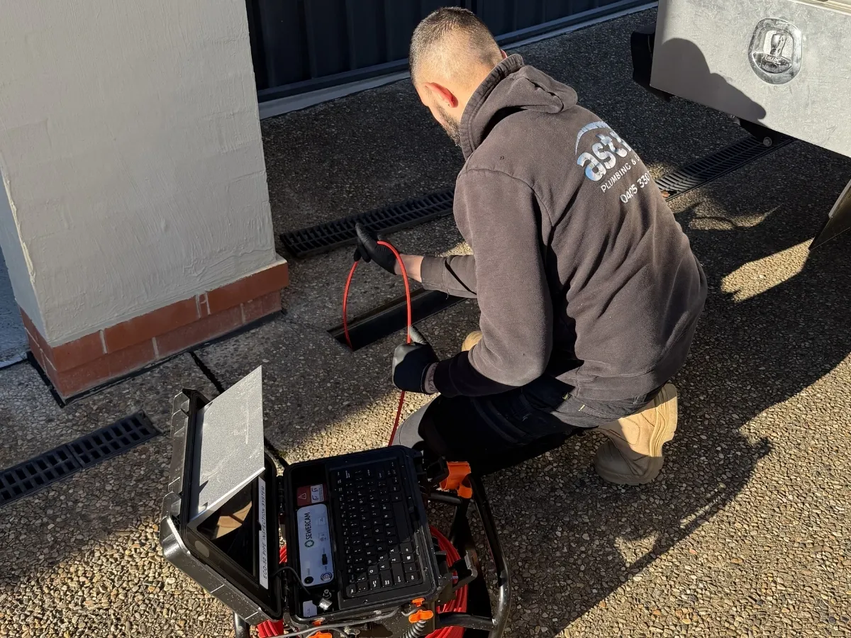 Nick inspecting a blocked drain using CCTV drain camera equipment.