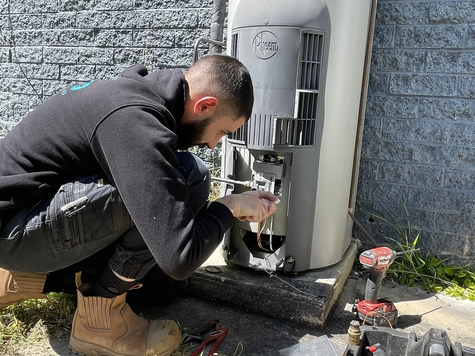 Nick repairing a gas hot water system in Canberra.